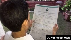 A man reads WhatsApp advertisements on how to spot misinformation, published in prominent newspapers in New Delhi, India, July 10, 2018.