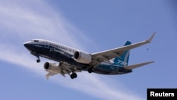 FILE PHOTO: A Boeing 737 MAX airplane lands after a test flight at Boeing Field in Seattle, Washington, U.S. June 29, 2020. REUTERS/Karen Ducey/File Photo