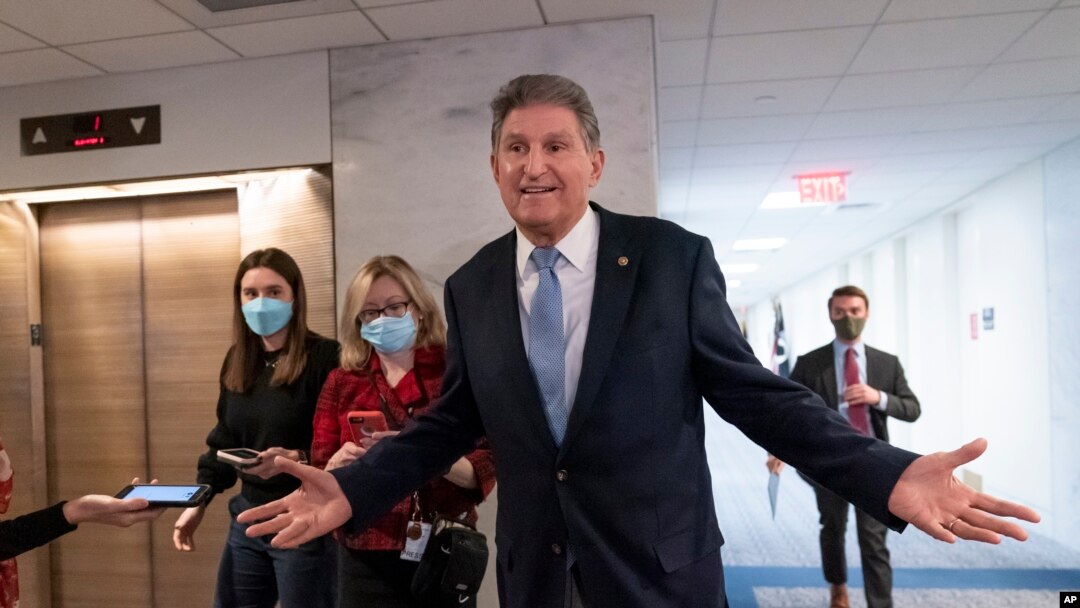 Sen. Joe Manchin, D-W.Va., leaves his office moments after speaking with President Joe Biden about his long-stalled domestic agenda, at the Capitol in Washington, Dec. 13, 2021.