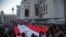 Members of the Lebanese community hold a giant Lebanese flag during a vigil in memory of victims of the deadly blast in Beirut, in front of Sacre Coeur Basilica in Paris, France, Aug. 5, 2020. 