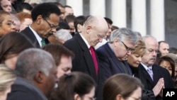 Members of Congress and staff members observe a moment of silence for Rep. Gabrielle Giffords, D-Ariz., and other shooting victims, Monday, Jan. 10, 2011, on the East Steps of the Capitol in Washington