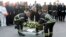Belgium's King Philippe, center, and firefighters lay a wreath in front of the damaged Zaventem Airport terminal in Brussels on March 23, 2016. 