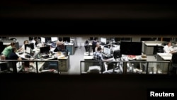 FILE - Journalists of Folha de S. Paulo newspaper work inside the editorial office of the newspaper in Sao Paulo, Brazil, Oct. 31, 2018. 