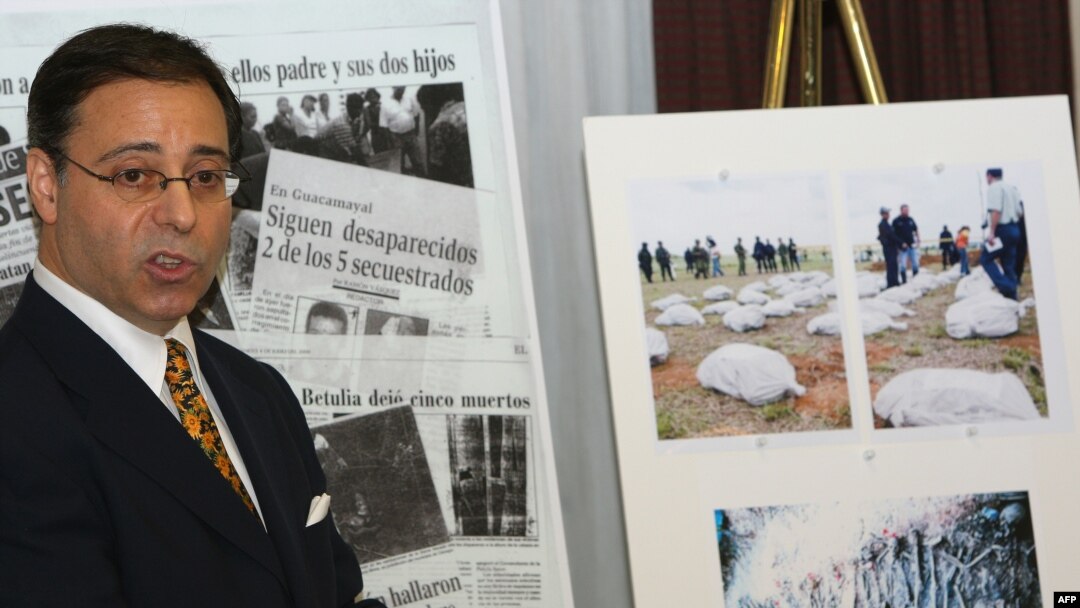 FILE - U.S. lawyer Jonathan Reiter addresses a press conference next to newspaper clippings and photos displaying stories of alleged torture and killing by Colombian paramilitaries on the payroll of banana giant Chiquita Brands International in New York, Nov. 14, 2007.