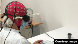 In this photo, a blind patient is seen taking part in experiments carried out by American and European researchers in the field of optogenetics. During the experiments, a 58-year-old blind man was able to use special eyeglasses to identify and count diffe