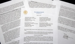 FILE - A copy of a letter from Attorney General William Barr advising Congress of the principal conclusions reached by special counsel Robert Mueller, is photographed in Washington, March 24, 2019.