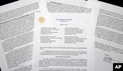 FILE - A copy of a letter from Attorney General William Barr advising Congress of the principal conclusions reached by special counsel Robert Mueller, is photographed in Washington, March 24, 2019.