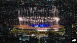 Fireworks illuminate over National Stadium during the closing ceremony of the 2020 Tokyo Olympics, Sunday, Aug. 8, 2021, in Tokyo. (AP Photo/Kiichiro Sato)