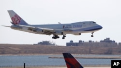 A China Airlines cargo jet lands at John F. Kennedy International Airport, Saturday, March 14, 2020, in New York. (AP Photo/Kathy Willens)