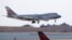 A China Airlines cargo jet lands at John F. Kennedy International Airport, Saturday, March 14, 2020, in New York. (AP Photo/Kathy Willens)
