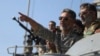 FILE - Iran's navy commander Habibollah Sayyari points while standing on a naval ship during Velayat-90 war game on Sea of Oman near the Strait of Hormuz in southern Iran, Jan. 1, 2012.