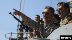 FILE - Iran's navy commander Habibollah Sayyari points while standing on a naval ship during Velayat-90 war game on Sea of Oman near the Strait of Hormuz in southern Iran, Jan. 1, 2012.