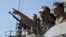 FILE - Iran's navy commander Habibollah Sayyari points while standing on a naval ship during Velayat-90 war game on Sea of Oman near the Strait of Hormuz in southern Iran, Jan. 1, 2012.
