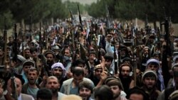 Afghan militiamen join Afghan defense and security forces during a gathering in Kabul, June 23, 2021.