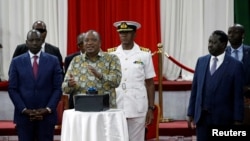 Kenya's President Uhuru Kenyatta, flanked by Kenyan Deputy President William Ruto and Opposition leader Raila Odinga launch the Building Bridges Initiative, a government report intended to address cyclical election violence in Nairobi, Nov. 27, 2019.