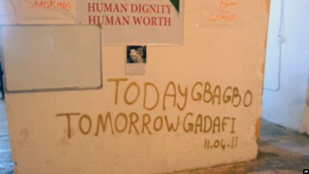 With a nod to events in Ivory Coast, graffiti reflects Libyan rebel demands that leader Moammar Gadhafi leave, April 12, 2011