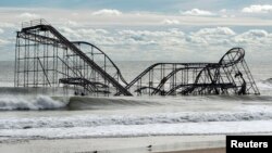 November 1, 2012: The remnants of a roller coaster sits in the surf three days after Hurricane Sandy came ashore in Seaside Heights, New Jersey.