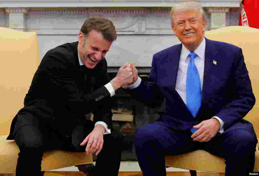 U.S. President Donald Trump and French President Emmanuel Macron react during their meeting at the White House in Washington.