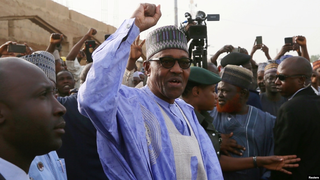 FILE - Nigerian President Muhammadu Buhari gestures as he arrives to cast a vote in Nigeria's presidential election at a polling station in Daura, Katsina State, Nigeria, Feb. 23, 2019.