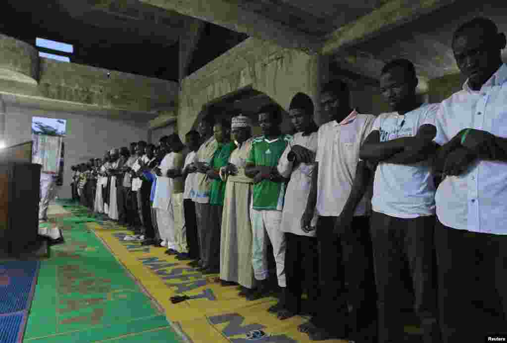 Men pray before breaking fast during the Islamic holy month of Ramadan at Nasfat Mosque in Utako, Abuja.