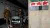 Rebel fighters stand next to an independence-era flag in the building of the Syria Car Trading Company, belonging to Hafez Munther al-Assad, a relative of ousted Syrian president Bashar al-Assad, in the western port city of Latakia on December 15, 2024.