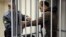 Photojournalist Denis Sinyakov, one of the 30 people detained in Greenpeace protest at Prirazlomnaya Arctic platform, in court defendants' box, Murmansk, Sept. 26, 2013.