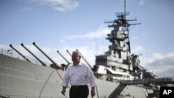 U.S. Secretary of Defense Robert Gates walks alongside the USS Missouri battleship during his visit to Hawaii, May 31, 2011