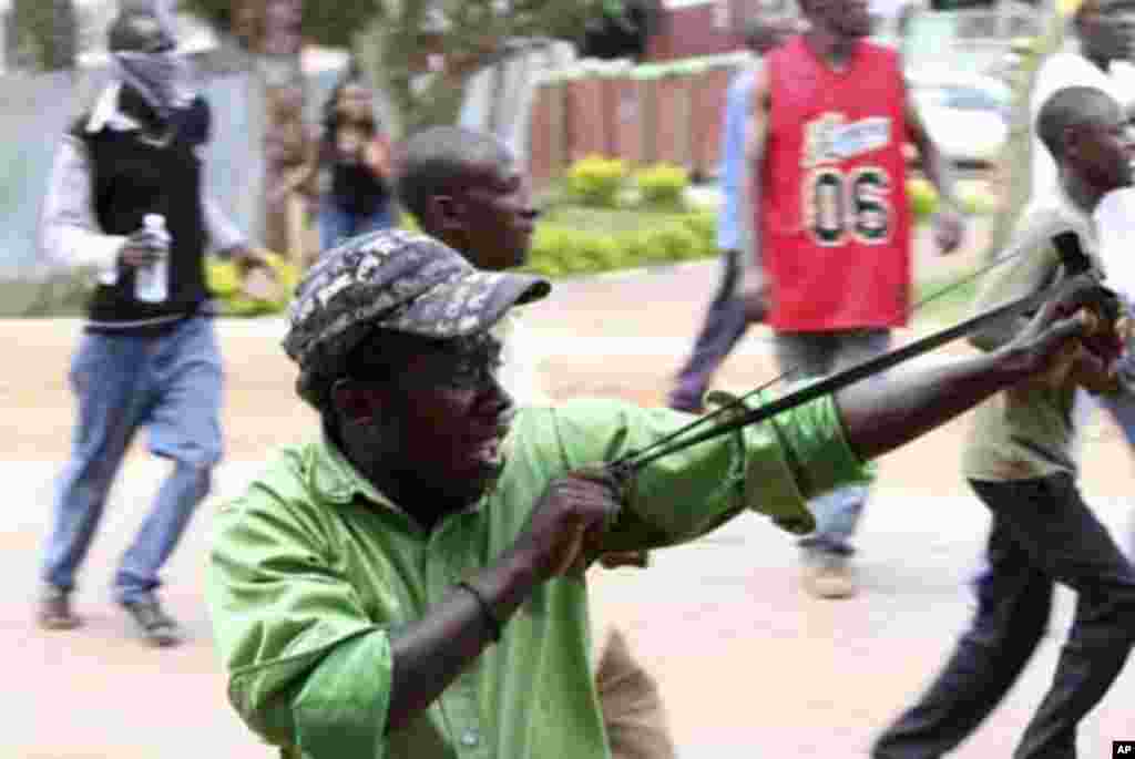 A demonstrator uses slingshot during a protest against the arrest of Ugandan opposition leader Kizza Besigye in Kireka suburb of the capital Kampala, April 18, 2011. Besigye was charged in court on Monday with engaging in riotous beahviour and inciting vi