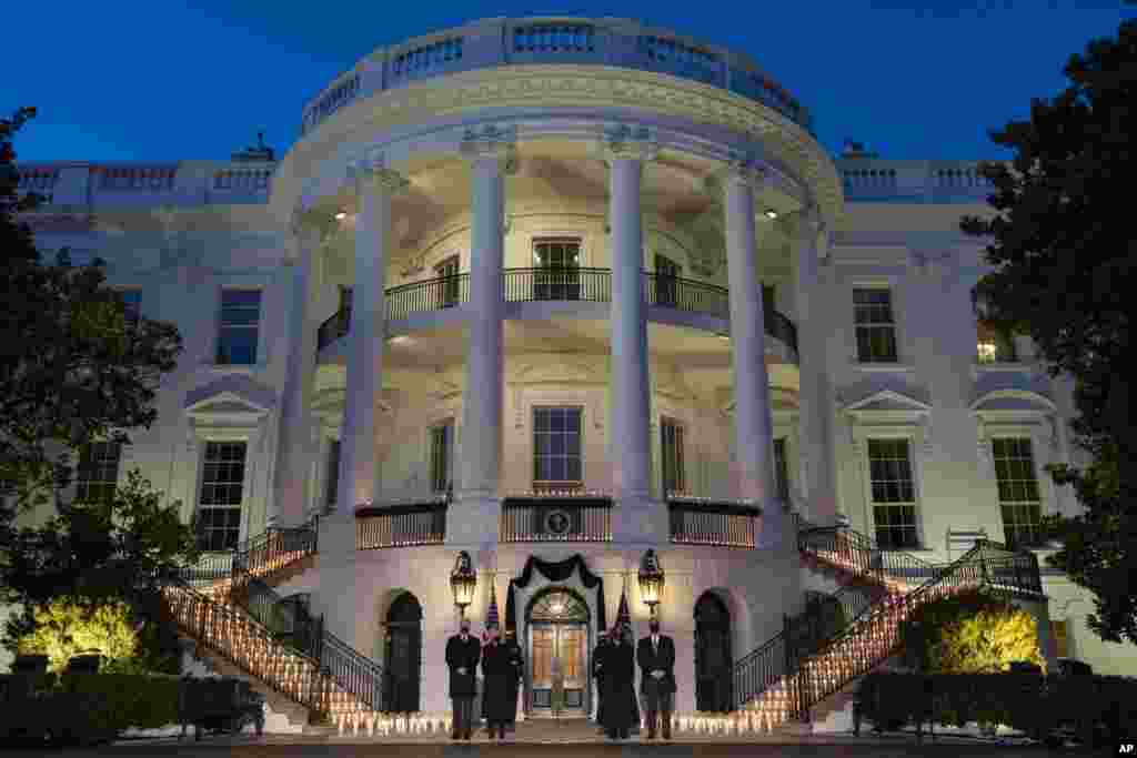 President Joe Biden, first lady Jill Biden, Vice President Kamala Harris, and Doug Emhoff participate in a moment of silence during a ceremony at the White House in Washinton, Feb. 22, 2021, to honor the 500,000 Americans who died from COVID-19.