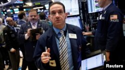 Traders work on the floor of the New York Stock Exchange shortly after the opening bell in New York, March 1, 2018. 