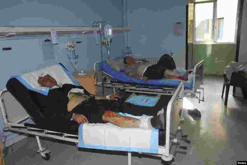 Men, who were injured in a bomb explosion in front of the al-Hejaz train station, lie down on beds at a hospital in central Damascus, Nov. 6, 2013. (SANA)