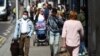 People walk down a street following the coronavirus disease (COVID-19) outbreak, London, July 29, 2020.