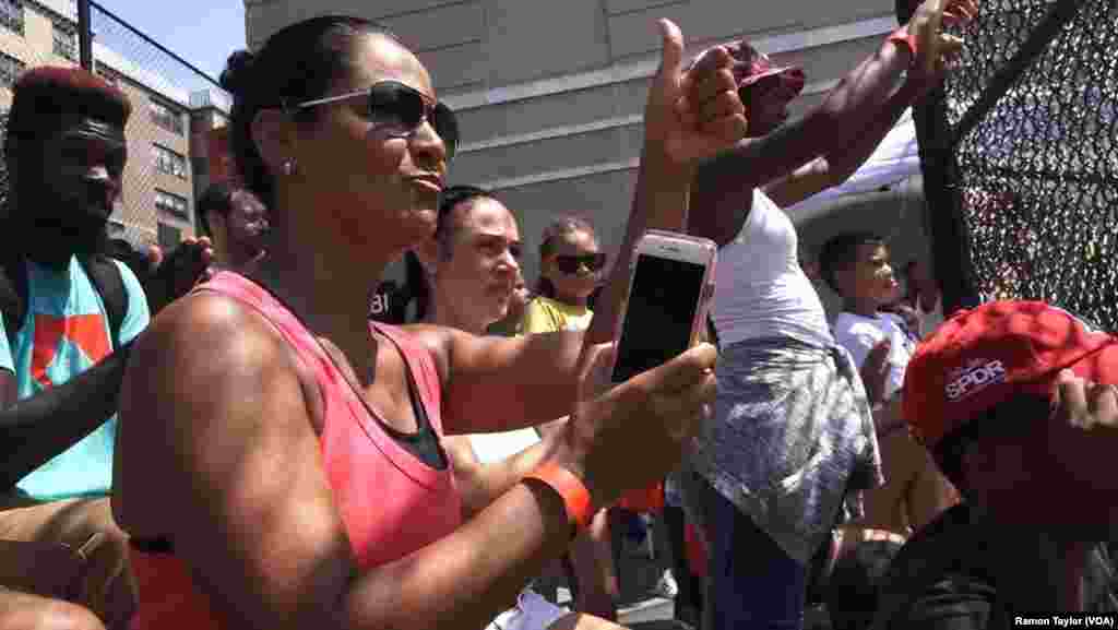 Marilyn Morales memberi semangat untuk putranya dari pinggir lapangan di Harlem, New York (12/8).