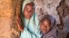 Aisha Amiru (with green hijab) said she and her younger sister look forward to getting married in a few years. (C. Oduah/VOA)