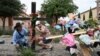 Muralist Roberto Marquez and his friend Israel Gil from Dallas erect a memorial on May 7, 2023 to honor those who lost their lives when a gunman shot multiple people at the Dallas-area Allen Premium Outlets mall in Allen, Texas.