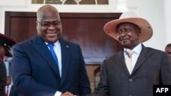 President of Democratic Republic of Congo (DRC) Felix Tshisekedi (L) shakes hands with Uganda's President Yoweri Museveni upon his arrival to discuss business between the two countries at the state house in Entebbe, Uganda, Nov. 9, 2019. 