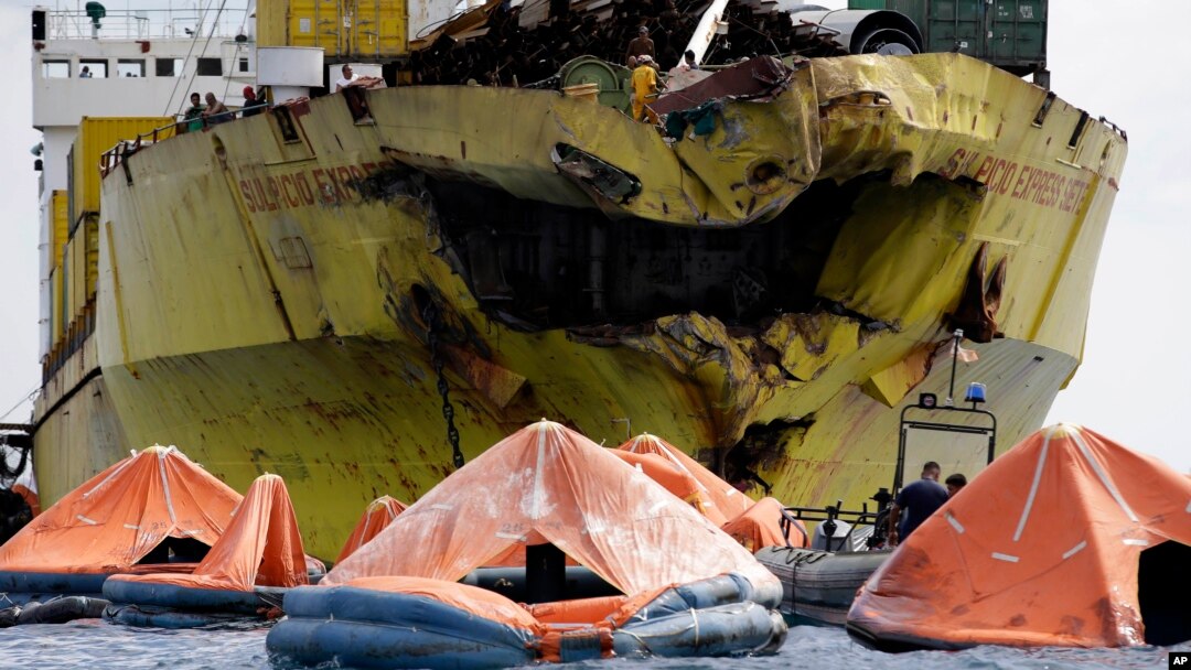 A cluster of life rafts floats near the cargo ship Sulpicio Express Siete, Aug. 17, 2013, a day after it collided with a passenger ferry off the waters of Talisay city, Cebu province in central Philippines. Divers combed through a sunken ferry Saturday to