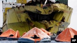 A cluster of life rafts floats near the cargo ship Sulpicio Express Siete, Aug. 17, 2013, a day after it collided with a passenger ferry off the waters of Talisay city, Cebu province in central Philippines. Divers combed through a sunken ferry Saturday to