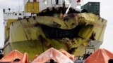 A cluster of life rafts floats near the cargo ship Sulpicio Express Siete a day after it collided with a passenger ferry off the waters of Talisay city, Cebu province in central Philippines. Divers combed through a sunken ferry to retrieve the bodies of more than 200 people still missing from an overnight collision.