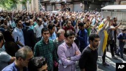 A group of protesters chant slogans at the old grand bazaar in Tehran, Iran, June 25, 2018. 