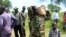An armed man carries boxes with forms delivered by members of Joint Military Ceasefire Commission (JMCC), meant to select soldiers from the opposition and the government into the South Sudanese military.