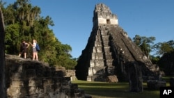 FILE - Tourists are seen at the Mayan ruins of Tikal, 500 kilometers north of Guatemala City, Aug. 20, 2005.