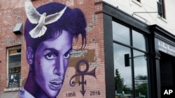 FILE - A mural honoring the late Prince adorns a building in the Uptown area of Minneapolis, Aug 28, 2016.