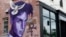 FILE - A mural honoring the late Prince adorns a building in the Uptown area of Minneapolis, Aug 28, 2016.