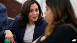 FILE - Democratic presidential candidate Sen. Kamala Harris, D-Calif., left, speaks with Astrid Silva, right, at an immigration roundtable at the University of Nevada, Las Vegas in Las Vegas, June 14, 2019. 