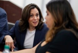 FILE - Democratic presidential candidate Sen. Kamala Harris, D-Calif., left, speaks with Astrid Silva, right, at an immigration roundtable at the University of Nevada, Las Vegas in Las Vegas, June 14, 2019.