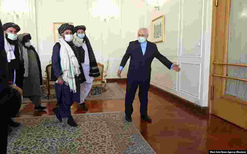 Iran&#39;s Foreign Minister Mohammad Javad Zarif meets with Taliban political chief Mullah Abdul Ghani Baradar in Tehran.