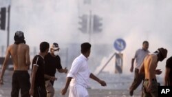 Riot police fire tear gas in Sitra, Bahrain, September 16, 2011.