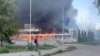 Smoke and flames rise from a shopping center damaged by shelling in the course of the Russia-Ukraine conflict, in Donetsk, Russian-controlled Ukraine, in this screengrab taken from a video released on Aug. 16, 2024. 