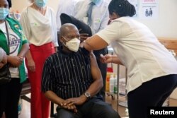 FILE - South African Health Minister Zweli Mkhize receives the Johnson and Johnson coronavirus disease (COVID-19) vaccination at the Khayelitsha Hospital near Cape Town, South Africa, Feb. 17, 2021.